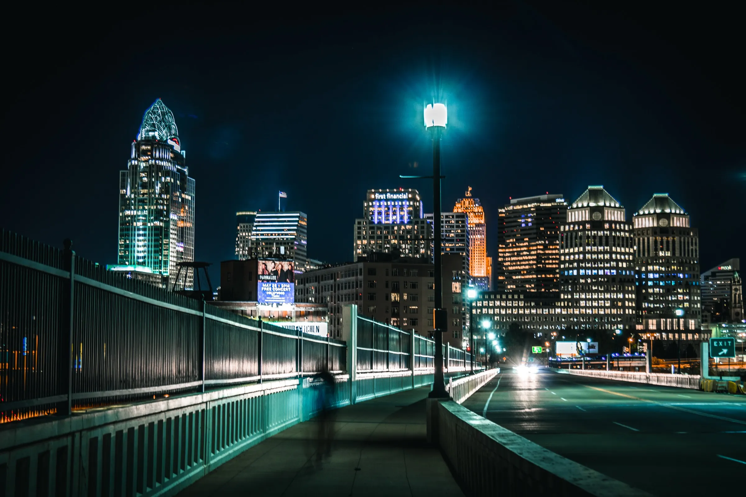 Cincinnati skyline at night from across the Roebling Bridge approach